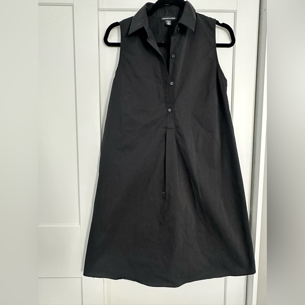 Cute black dress. Small spot as shown in the photos.